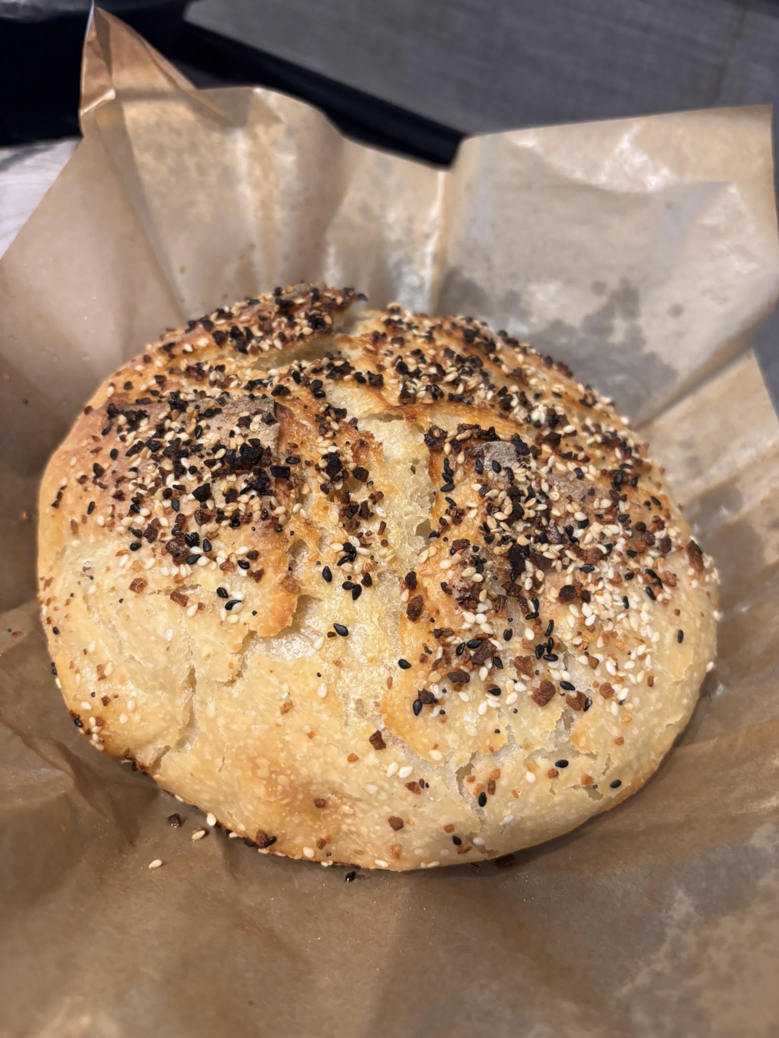 A sourdough loaf topped with everything bagel seasoning