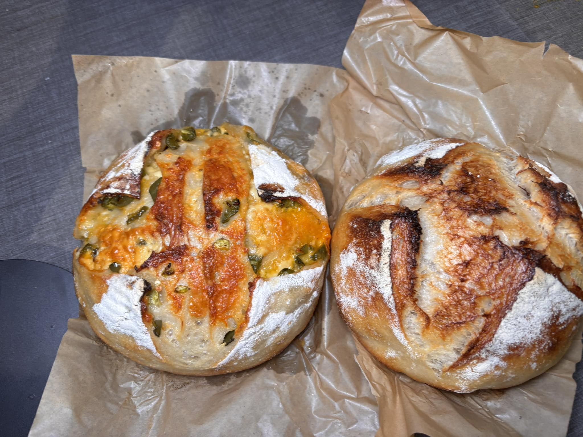 Two sourdough loaves with a cheese & jalapeño topping