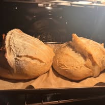 Two sourdough loaves in the oven